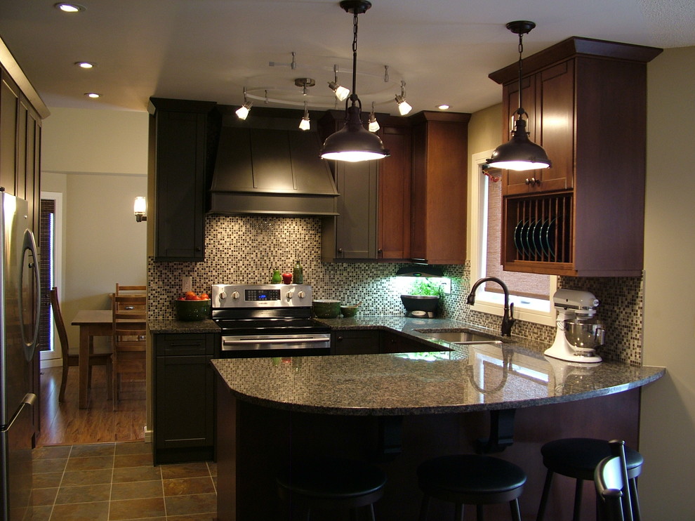 Small elegant u-shaped linoleum floor eat-in kitchen photo in Calgary with an undermount sink, shaker cabinets, medium tone wood cabinets, granite countertops, multicolored backsplash, stainless steel appliances and a peninsula