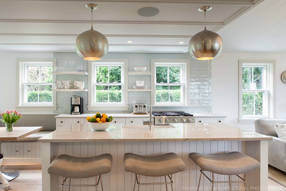 Photo of a medium sized beach style single-wall open plan kitchen in Boston with white cabinets, granite worktops, green splashback, metro tiled splashback and an island.
