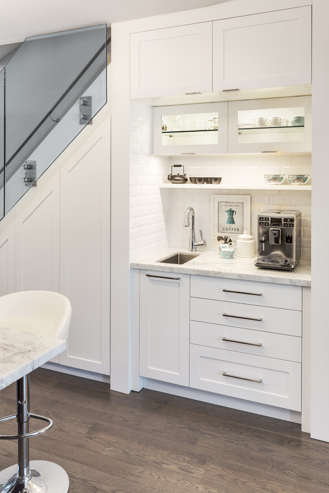 Example of a small trendy single-wall dark wood floor open concept kitchen design in Other with an undermount sink, shaker cabinets, white cabinets, white backsplash, subway tile backsplash, marble countertops, stainless steel appliances and an island