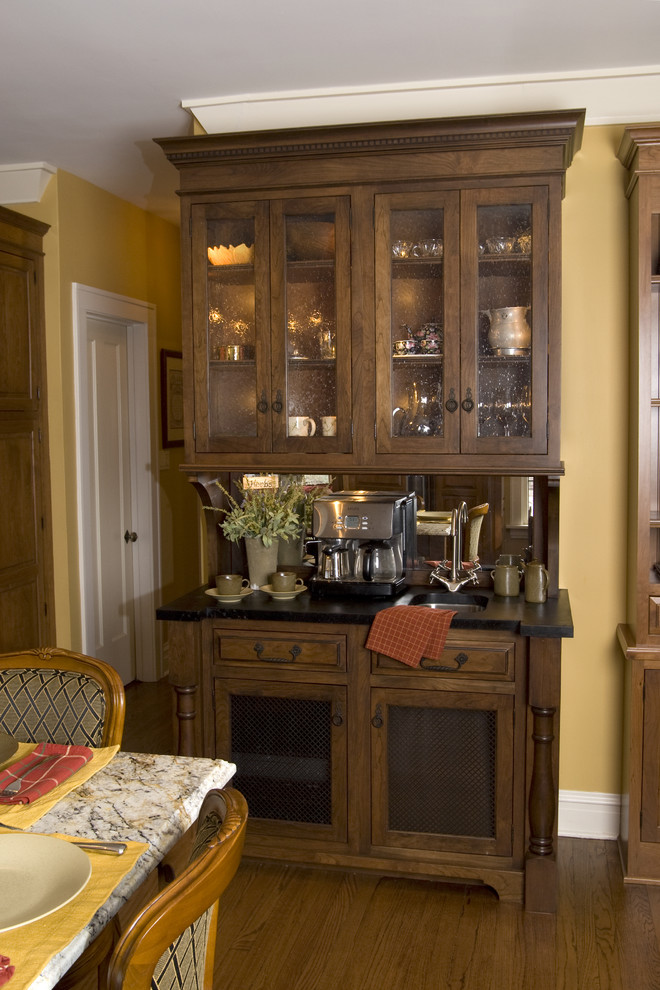This is an example of a traditional kitchen in Chicago with dark wood cabinets.
