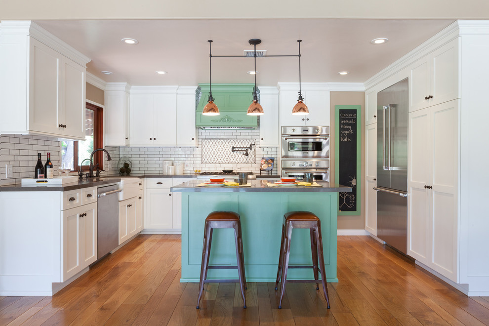 Country medium tone wood floor kitchen photo in Los Angeles with shaker cabinets, white cabinets, white backsplash and an island