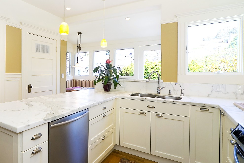 Elegant kitchen photo in San Francisco with stainless steel appliances, an undermount sink and marble countertops
