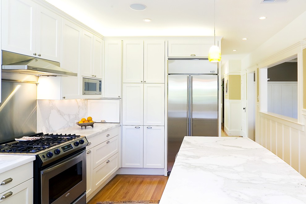 Photo of a classic kitchen in San Francisco with stainless steel appliances, marble worktops and marble splashback.