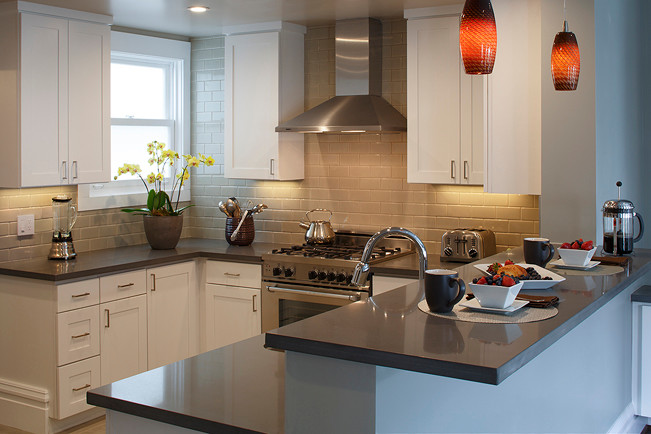 Example of a small trendy u-shaped concrete floor eat-in kitchen design in San Francisco with flat-panel cabinets, white cabinets, a peninsula, an undermount sink, quartz countertops, gray backsplash, subway tile backsplash and stainless steel appliances