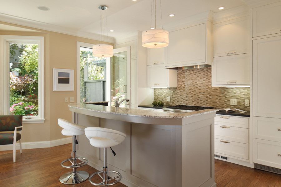 Kitchen - mid-sized transitional galley medium tone wood floor kitchen idea in San Francisco with a single-bowl sink, recessed-panel cabinets, beige cabinets, granite countertops, green backsplash, glass tile backsplash, stainless steel appliances and an island