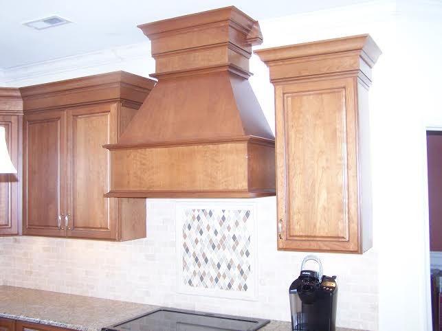 Inspiration for a timeless l-shaped eat-in kitchen remodel in Philadelphia with an undermount sink, raised-panel cabinets, medium tone wood cabinets, granite countertops, beige backsplash, stone tile backsplash and black appliances