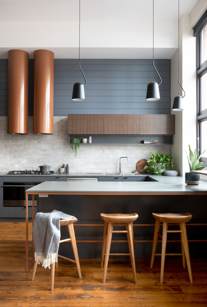 Mid-sized trendy u-shaped medium tone wood floor and brown floor eat-in kitchen photo in Melbourne with a double-bowl sink, flat-panel cabinets, gray cabinets, quartz countertops, gray backsplash, ceramic backsplash, stainless steel appliances, an island and gray countertops
