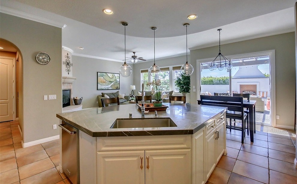 Example of a large transitional u-shaped terra-cotta tile and multicolored floor open concept kitchen design in San Diego with an undermount sink, marble countertops, stainless steel appliances and an island