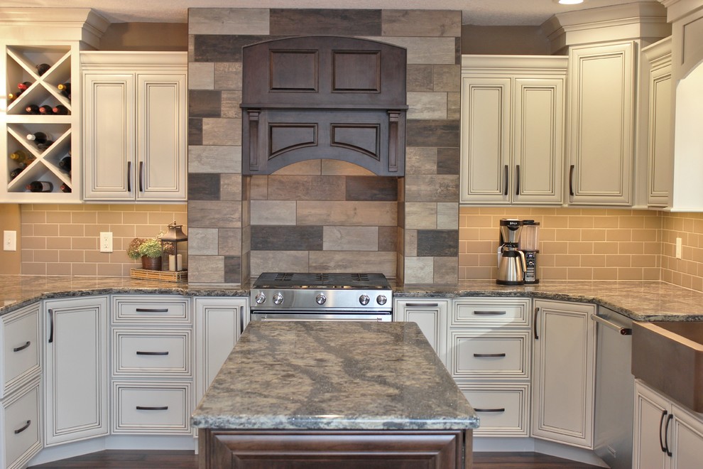 Inspiration for a large traditional u-shaped kitchen/diner in Chicago with a belfast sink, flat-panel cabinets, beige cabinets, engineered stone countertops, brown splashback, ceramic splashback, stainless steel appliances, vinyl flooring and an island.