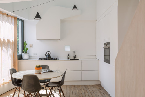 Simple and Stylish: Minimalist Kitchen with a Small Circular Dining Set