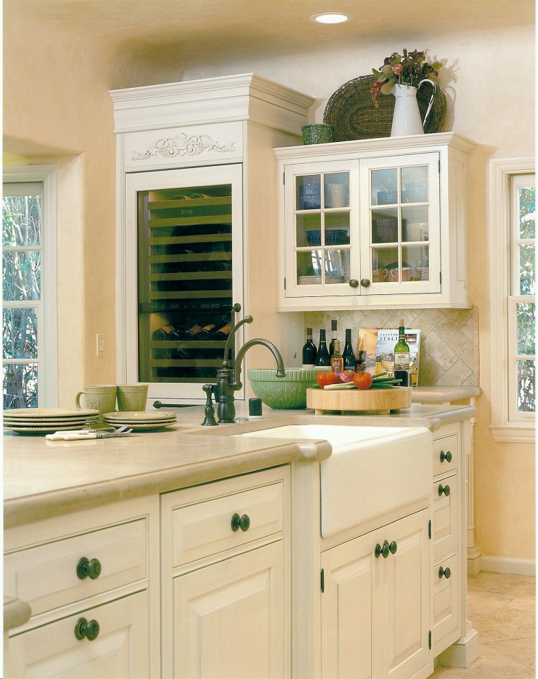 Design ideas for a medium sized shabby-chic style l-shaped kitchen/diner in San Luis Obispo with a belfast sink, beaded cabinets, yellow cabinets, limestone worktops, beige splashback, stone tiled splashback, integrated appliances, travertine flooring, an island, beige floors, beige worktops and a coffered ceiling.