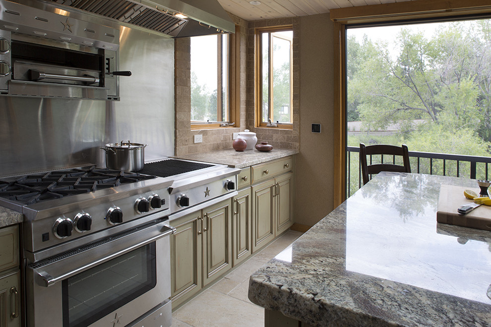 Bild på ett stort vintage vit vitt kök, med en rustik diskho, luckor med upphöjd panel, skåp i slitet trä, granitbänkskiva, stänkskydd i stenkakel, rostfria vitvaror, klinkergolv i keramik, en köksö, beiget golv och brunt stänkskydd