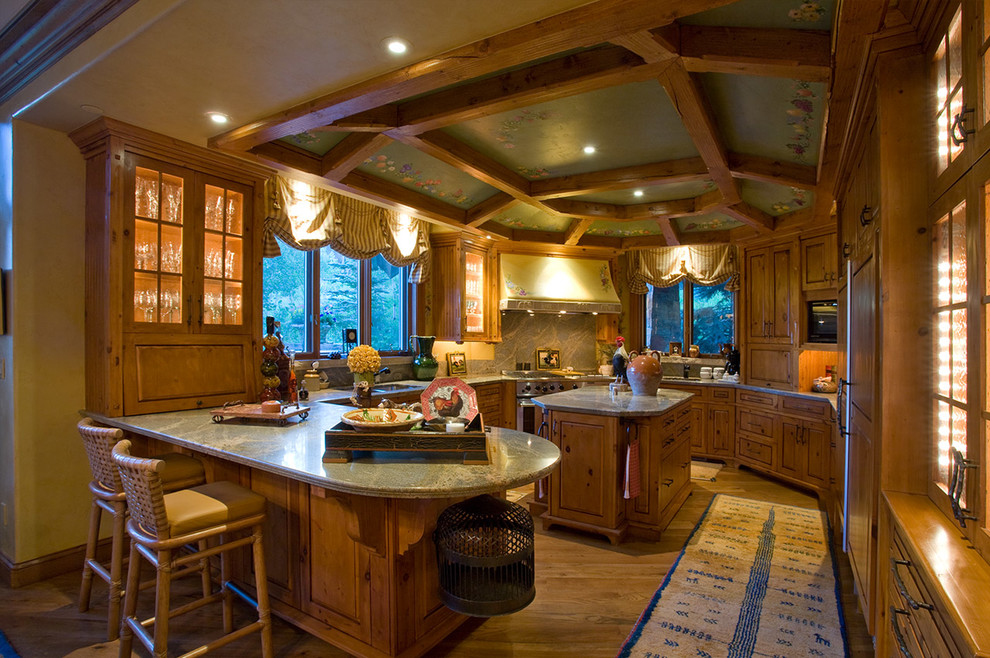 Inspiration for a large country u-shaped kitchen/diner in Indianapolis with a submerged sink, raised-panel cabinets, medium wood cabinets, granite worktops, green splashback, stainless steel appliances, medium hardwood flooring, an island and beige floors.