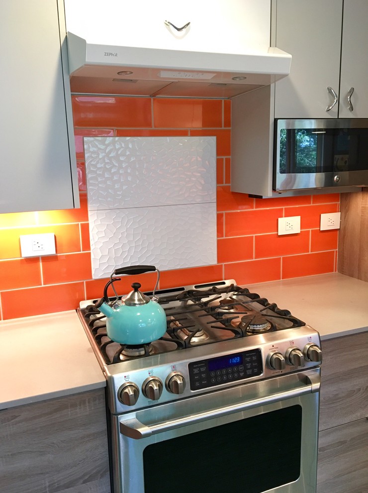 This is an example of a small retro galley enclosed kitchen in Other with a single-bowl sink, flat-panel cabinets, grey cabinets, engineered stone countertops, orange splashback, ceramic splashback, stainless steel appliances, lino flooring, no island and turquoise floors.