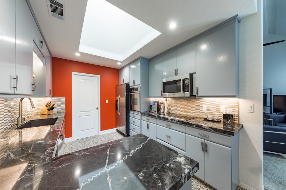 Example of a mid-sized asian u-shaped cork floor and multicolored floor open concept kitchen design in Other with an integrated sink, flat-panel cabinets, blue cabinets, granite countertops, multicolored backsplash, matchstick tile backsplash, stainless steel appliances, a peninsula and black countertops