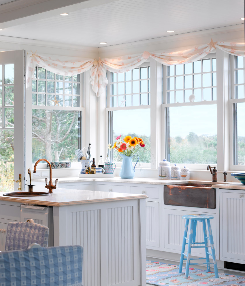 Beach style eat-in kitchen photo in Boston with a farmhouse sink and white cabinets