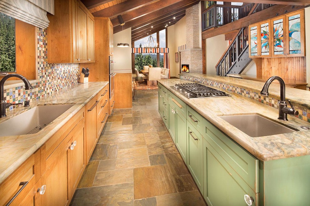 Eclectic single-wall slate floor eat-in kitchen photo in Other with an undermount sink, shaker cabinets, granite countertops, multicolored backsplash, stone tile backsplash, stainless steel appliances, an island and medium tone wood cabinets