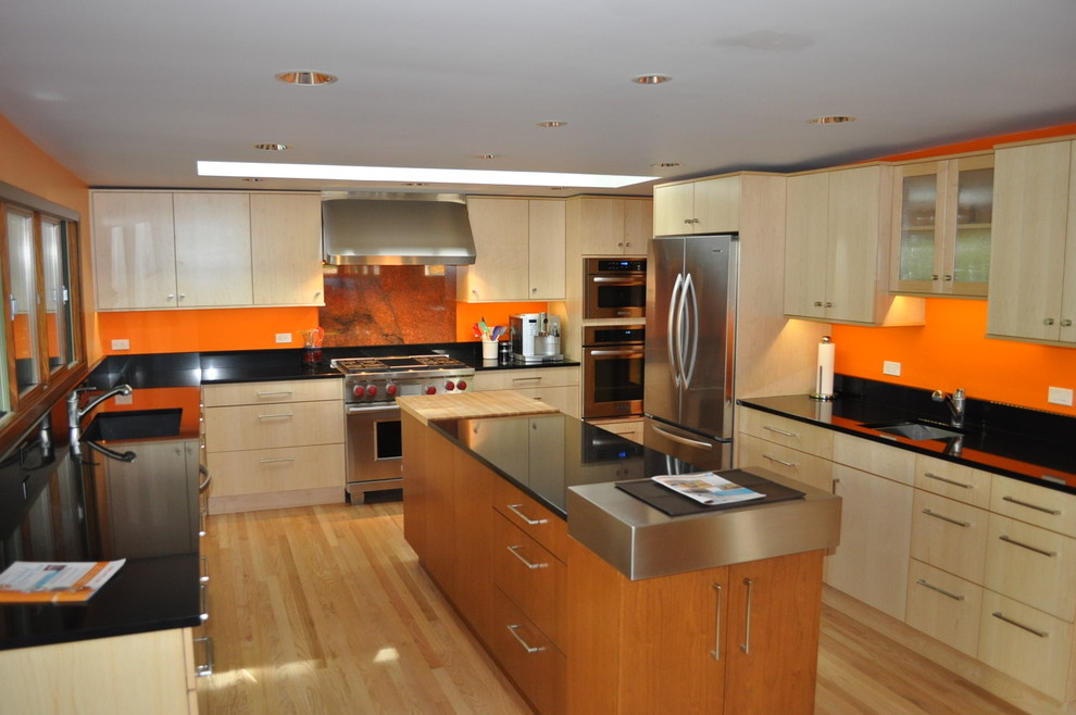 Eat-in kitchen - mid-sized contemporary u-shaped light wood floor and brown floor eat-in kitchen idea in Boise with a drop-in sink, flat-panel cabinets, light wood cabinets, granite countertops, stainless steel appliances and an island