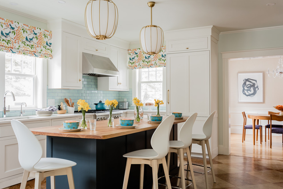 Kitchen - transitional l-shaped multicolored floor kitchen idea in Boston with an undermount sink, shaker cabinets, white cabinets, blue backsplash, subway tile backsplash, stainless steel appliances, an island and white countertops