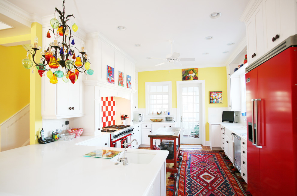 Photo of an eclectic kitchen in Other with coloured appliances, shaker cabinets and white cabinets.