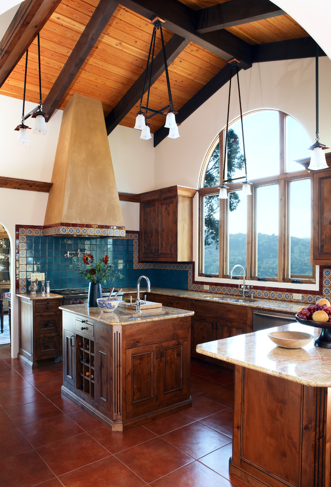 Mid-sized tuscan u-shaped terra-cotta tile enclosed kitchen photo in San Francisco with an undermount sink, beaded inset cabinets, dark wood cabinets, granite countertops, multicolored backsplash, ceramic backsplash, stainless steel appliances and an island