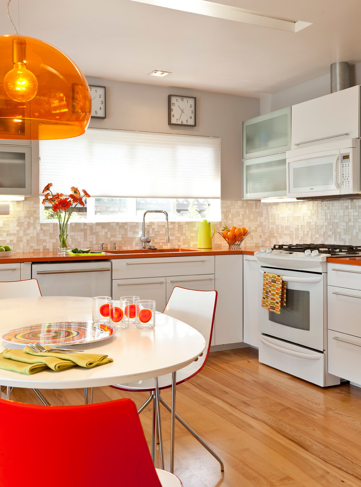 1950s eat-in kitchen photo in Other with mosaic tile backsplash, flat-panel cabinets, white cabinets, quartz countertops, beige backsplash, white appliances and orange countertops