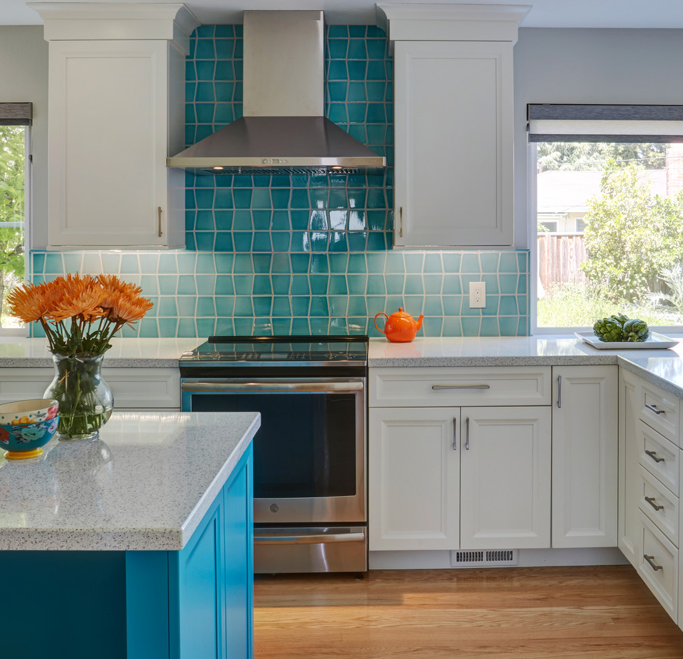Inspiration for a mid-sized transitional u-shaped medium tone wood floor and brown floor eat-in kitchen remodel in San Francisco with an undermount sink, recessed-panel cabinets, blue cabinets, blue backsplash, stainless steel appliances, an island and white countertops