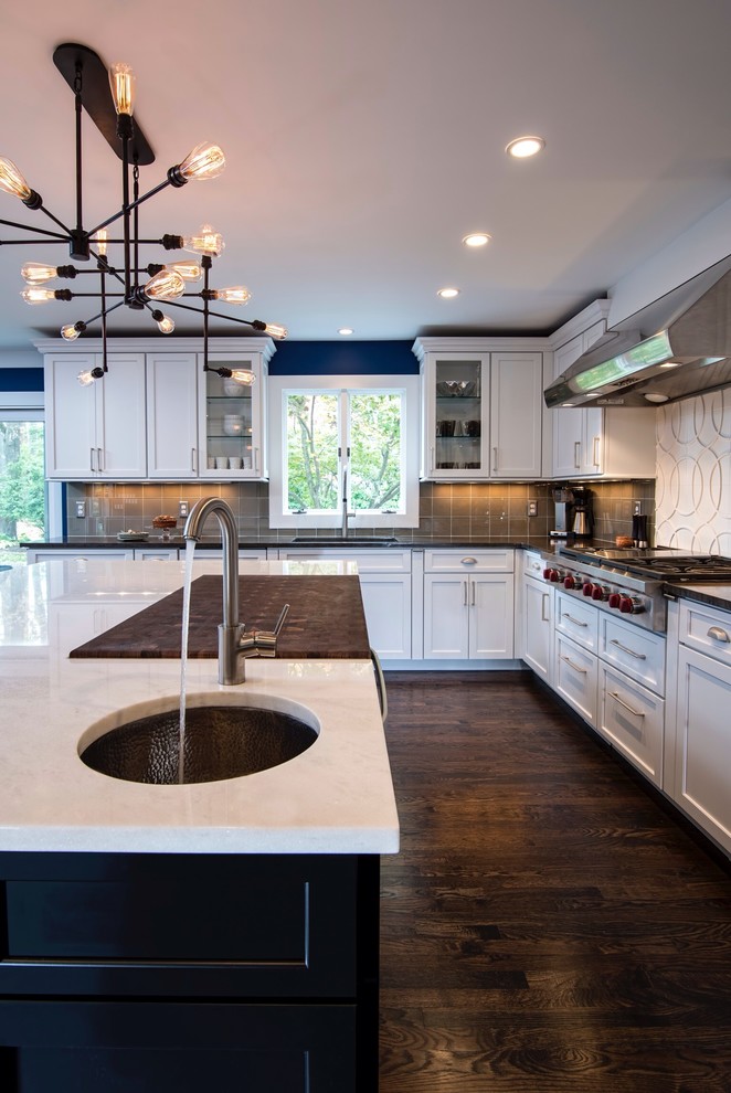 Eat-in kitchen - large transitional u-shaped dark wood floor eat-in kitchen idea in New York with an undermount sink, recessed-panel cabinets, white cabinets, brown backsplash, marble countertops, an island, glass tile backsplash and stainless steel appliances