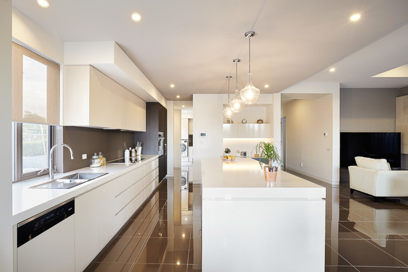 Contemporary single-wall kitchen pantry in Melbourne with a double-bowl sink, raised-panel cabinets, white cabinets, engineered stone countertops, brown splashback, glass sheet splashback, stainless steel appliances, ceramic flooring and an island.