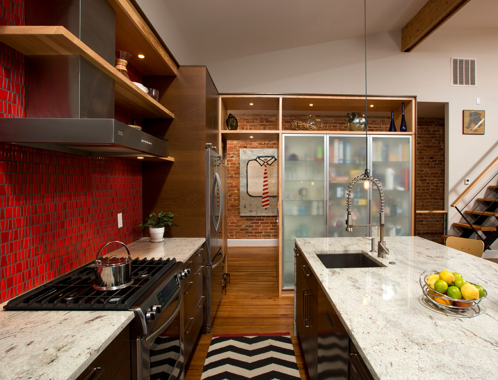 Eat-in kitchen - mid-sized contemporary single-wall medium tone wood floor eat-in kitchen idea in DC Metro with a single-bowl sink, flat-panel cabinets, brown cabinets, granite countertops, red backsplash, porcelain backsplash, stainless steel appliances and an island