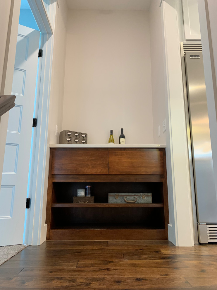 Large transitional galley medium tone wood floor, brown floor and shiplap ceiling eat-in kitchen photo in Other with a farmhouse sink, recessed-panel cabinets, white cabinets, quartz countertops, blue backsplash, ceramic backsplash, stainless steel appliances, an island and white countertops