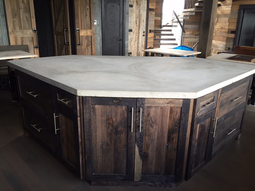 Example of a large urban l-shaped dark wood floor open concept kitchen design in Other with a farmhouse sink, recessed-panel cabinets, distressed cabinets, concrete countertops, metallic backsplash, metal backsplash, stainless steel appliances and an island