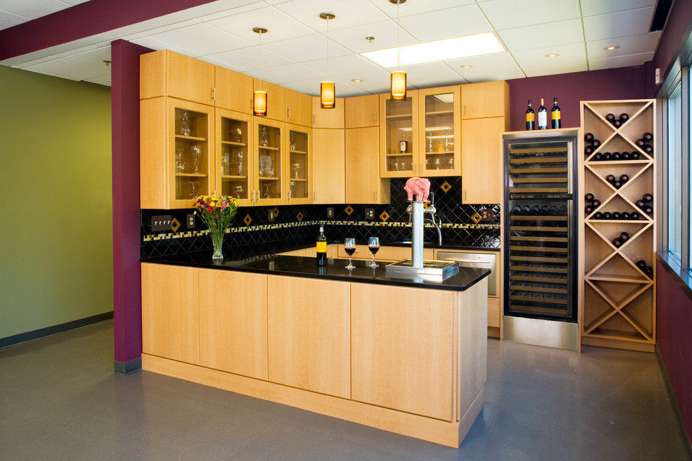 Example of a mid-sized trendy u-shaped vinyl floor enclosed kitchen design in DC Metro with an undermount sink, flat-panel cabinets, light wood cabinets, onyx countertops, black backsplash, ceramic backsplash, stainless steel appliances and a peninsula