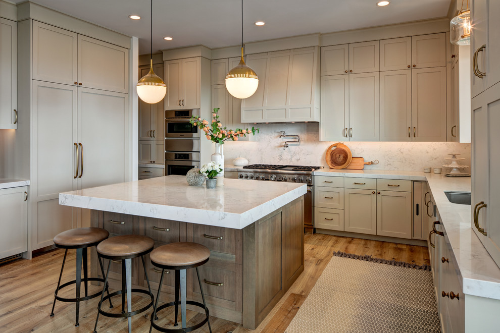 Large minimalist u-shaped light wood floor open concept kitchen photo in Salt Lake City with a farmhouse sink, recessed-panel cabinets, gray cabinets, marble countertops, multicolored backsplash, marble backsplash, stainless steel appliances, an island and multicolored countertops