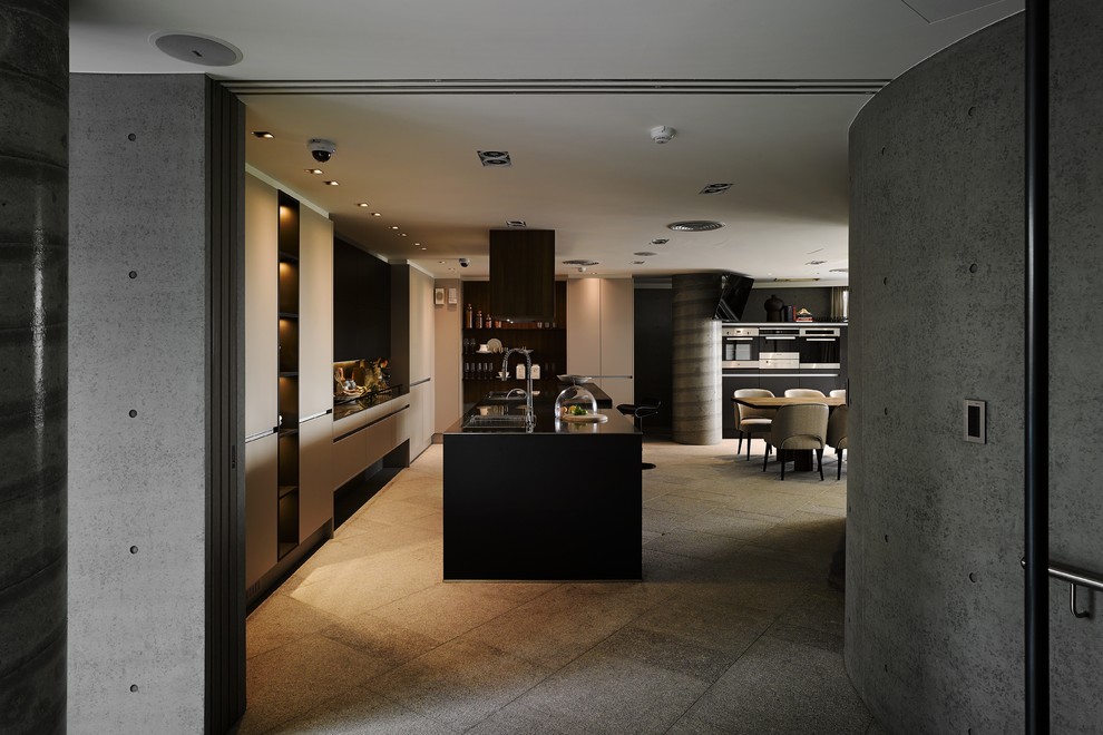 Foto på ett stort funkis kök, med en dubbel diskho, släta luckor, grå skåp, bänkskiva i rostfritt stål, grått stänkskydd, stänkskydd i sten, rostfria vitvaror, betonggolv och en köksö