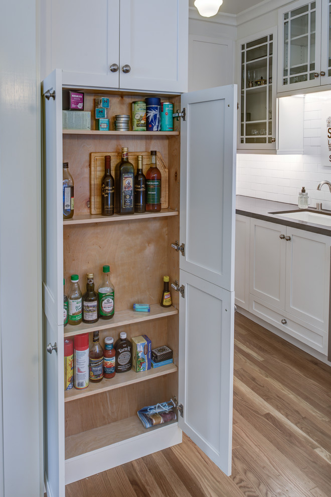 Inspiration for a small contemporary galley light wood floor kitchen pantry remodel in San Francisco with an undermount sink, shaker cabinets, white cabinets, brown backsplash, ceramic backsplash, stainless steel appliances and no island