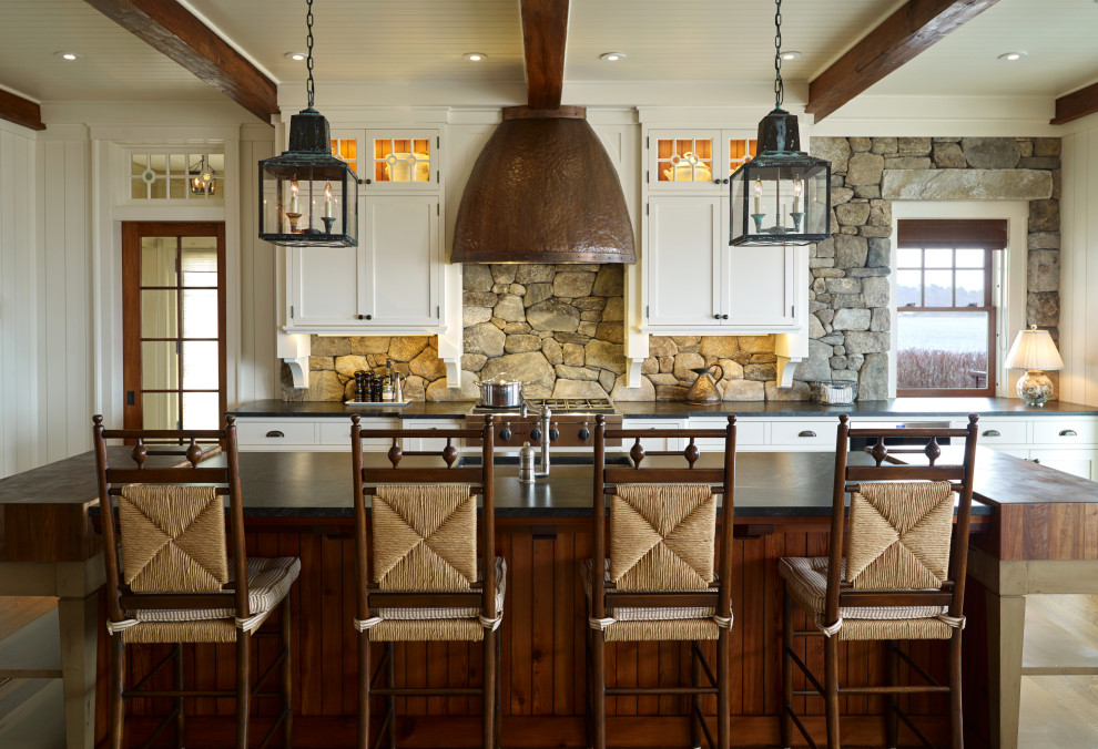 This is an example of a beach style kitchen in Portland Maine with exposed beams.