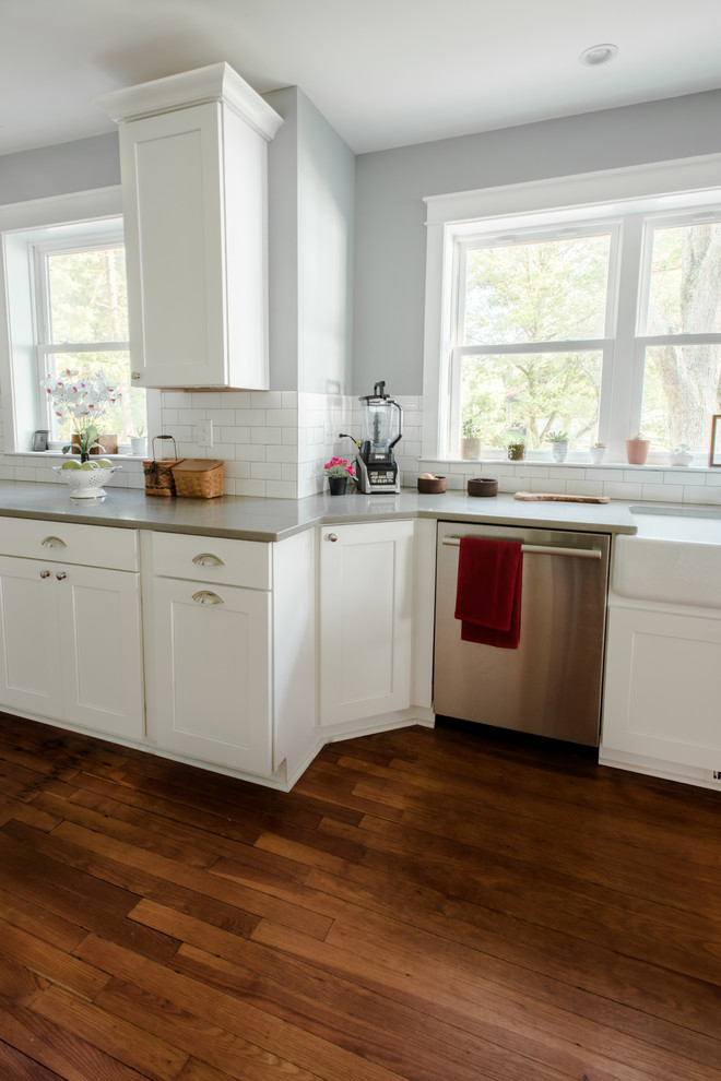 Inspiration for a large cottage galley medium tone wood floor and brown floor eat-in kitchen remodel in Baltimore with a farmhouse sink, white cabinets, granite countertops, white backsplash, subway tile backsplash and stainless steel appliances