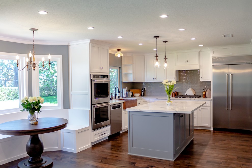 Mid-sized trendy galley dark wood floor and brown floor open concept kitchen photo in Los Angeles with a double-bowl sink, open cabinets, white cabinets, marble countertops, gray backsplash, glass tile backsplash, stainless steel appliances, an island and white countertops