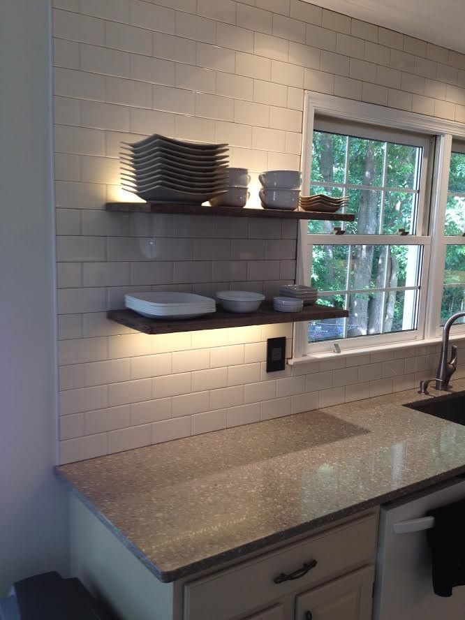 Medium sized country kitchen in Baltimore with a submerged sink, raised-panel cabinets, white cabinets, recycled glass countertops, white splashback, metro tiled splashback, stainless steel appliances and an island.
