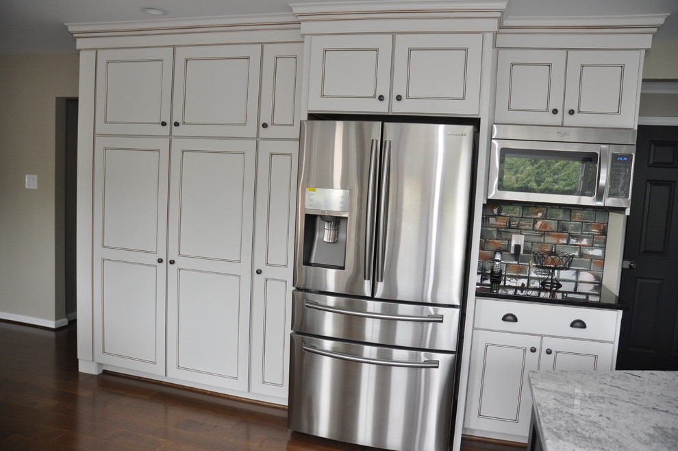 Photo of a large contemporary u-shaped kitchen/diner in DC Metro with a submerged sink, stainless steel appliances, an island and granite worktops.