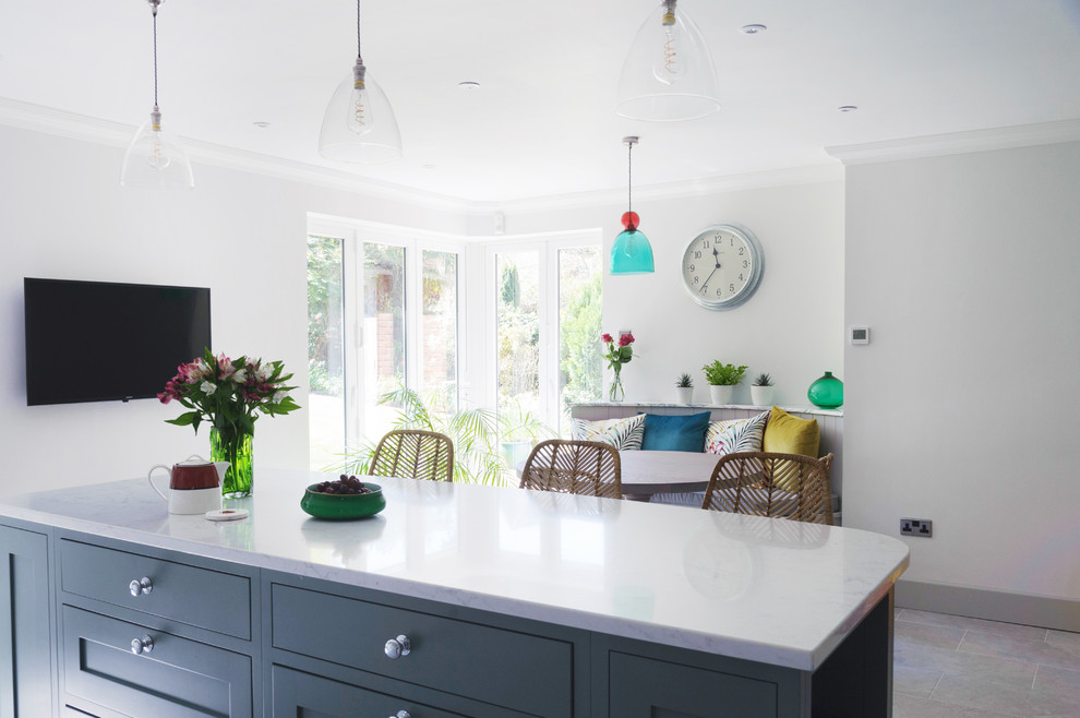 Medium sized classic kitchen/diner in Sussex with a double-bowl sink, shaker cabinets, grey cabinets, composite countertops, white splashback, marble splashback, stainless steel appliances, porcelain flooring, an island, grey floors and grey worktops.