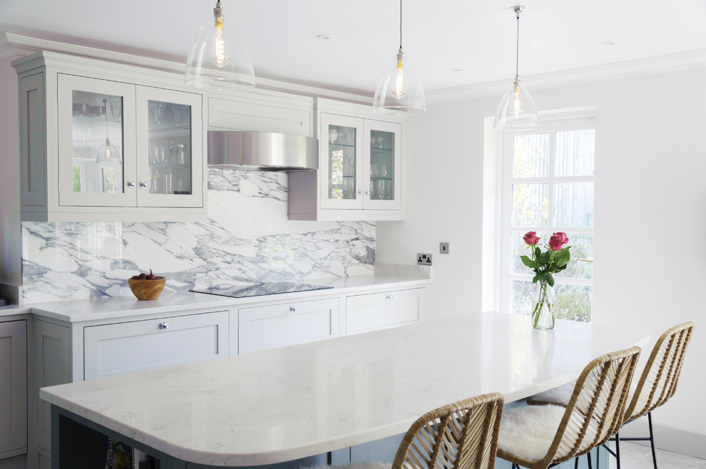 Medium sized traditional kitchen/diner in Sussex with a double-bowl sink, shaker cabinets, grey cabinets, composite countertops, white splashback, marble splashback, stainless steel appliances, porcelain flooring, an island, grey floors and grey worktops.