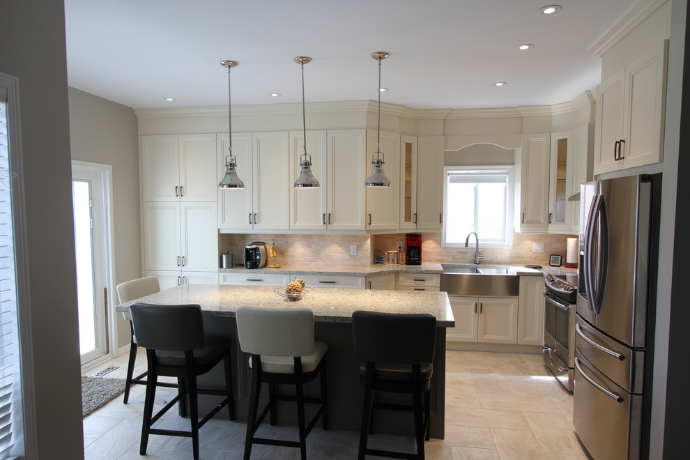 Photo of a medium sized contemporary l-shaped kitchen/diner in Toronto with a belfast sink, recessed-panel cabinets, beige cabinets, granite worktops, beige splashback, stone tiled splashback, stainless steel appliances, porcelain flooring and an island.