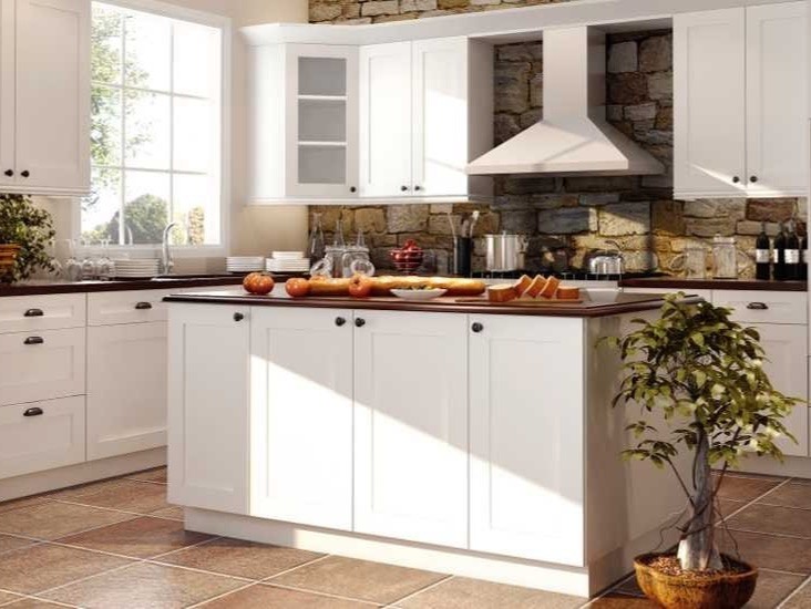Design ideas for a medium sized rural l-shaped enclosed kitchen in Phoenix with a submerged sink, shaker cabinets, white cabinets, wood worktops, beige splashback, stone tiled splashback, white appliances, terracotta flooring and an island.