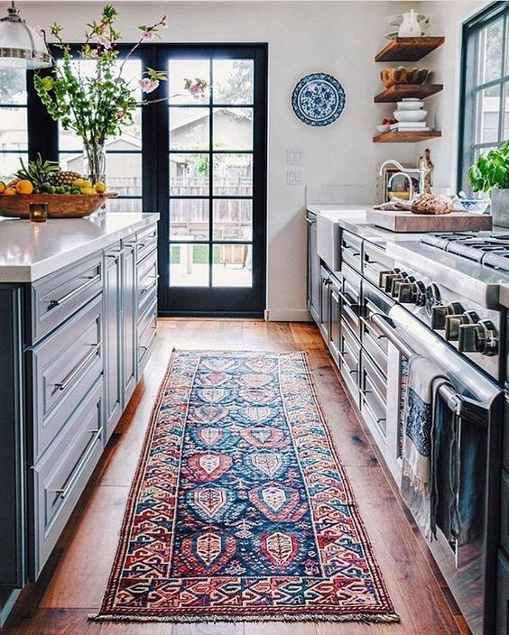 Large tuscan galley dark wood floor and brown floor eat-in kitchen photo in New York with a farmhouse sink, raised-panel cabinets, blue cabinets, quartz countertops, stainless steel appliances and an island