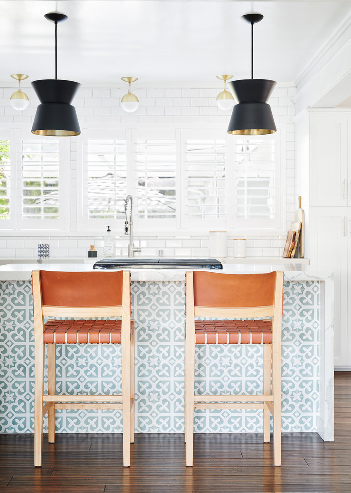 Beach style dark wood floor and brown floor kitchen photo in San Francisco with shaker cabinets, white cabinets, white backsplash, subway tile backsplash, an island and white countertops