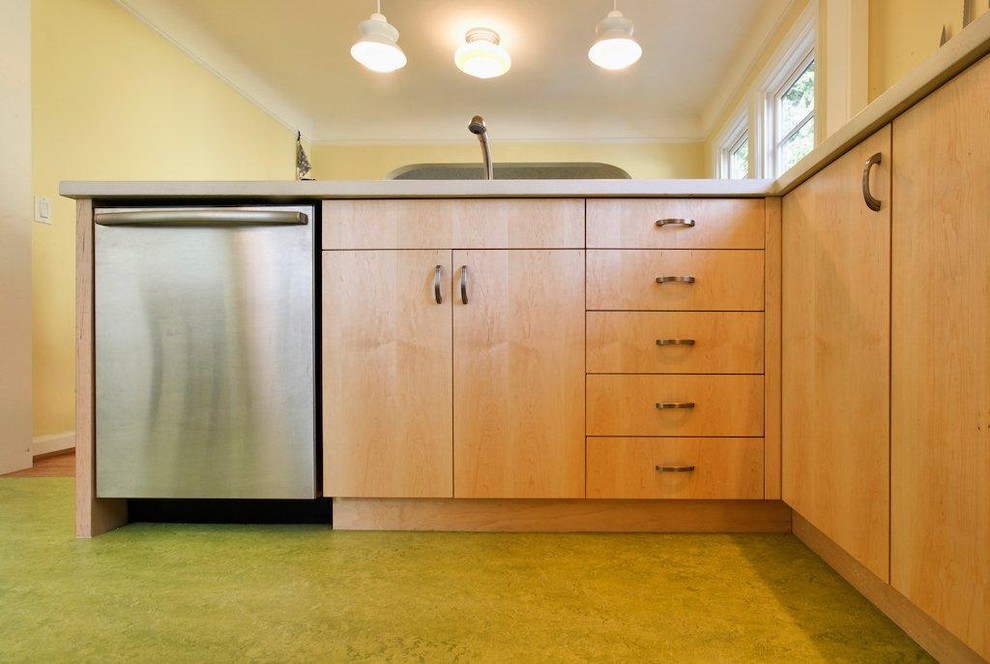 Inspiration for a transitional l-shaped eat-in kitchen remodel in Portland with flat-panel cabinets, light wood cabinets, concrete countertops and stainless steel appliances