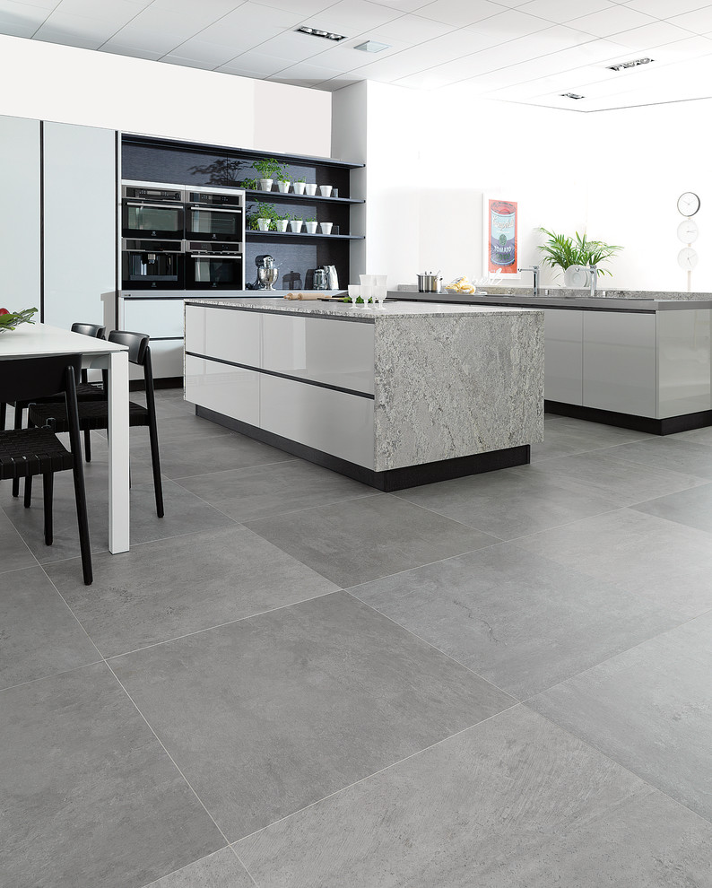 Example of an urban u-shaped porcelain tile eat-in kitchen design in Perth with white cabinets, marble countertops, gray backsplash, glass sheet backsplash, stainless steel appliances, an island, an undermount sink and flat-panel cabinets