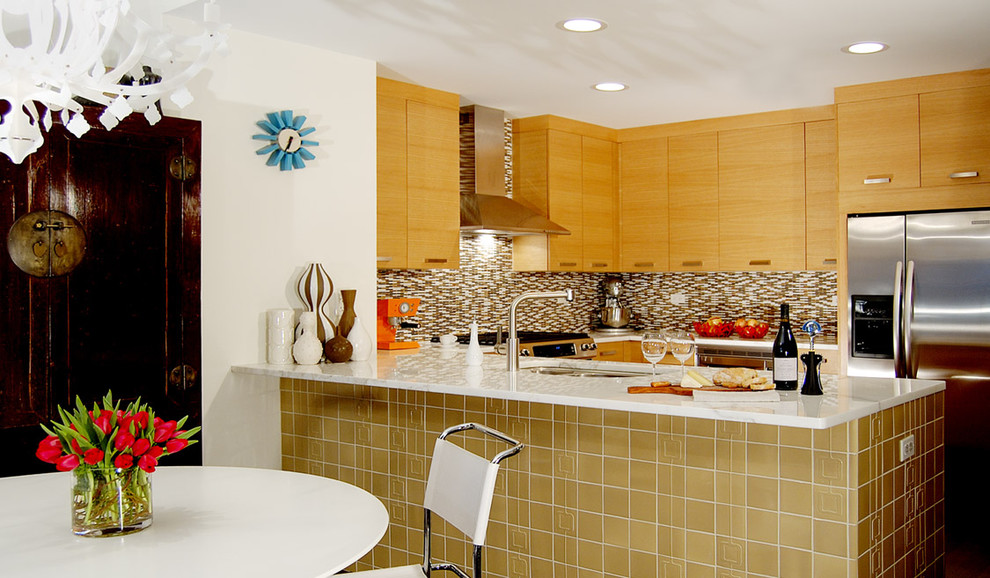 Mid-sized trendy u-shaped eat-in kitchen photo in Chicago with stainless steel appliances, an undermount sink, flat-panel cabinets, medium tone wood cabinets, marble countertops, matchstick tile backsplash, multicolored backsplash and no island
